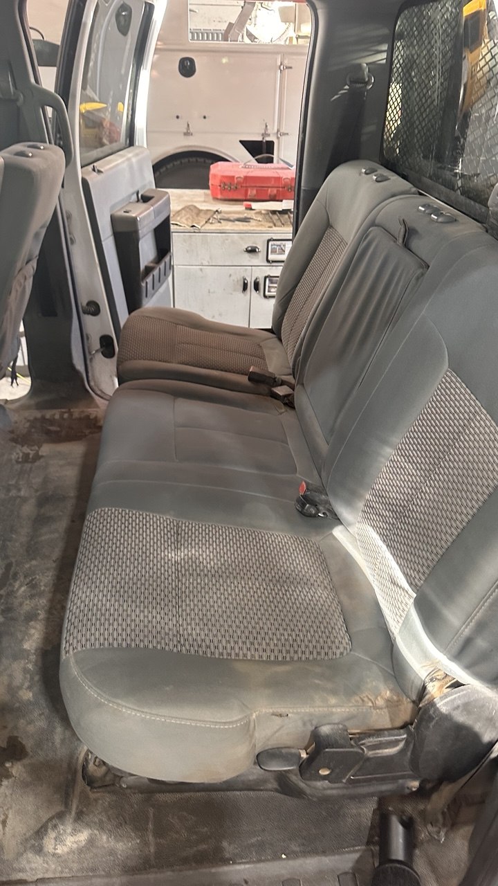 Soiled, dust-greyed truck rear seats before cleaning